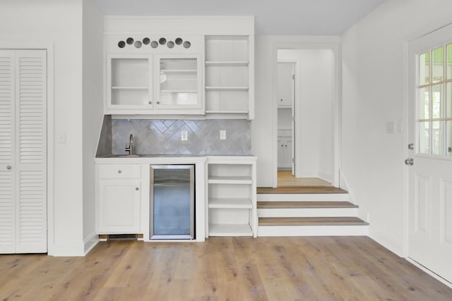 509 Hill St, Moncks Corner, SC 29461 - indoor wet bar with beverage cooler, baseboards, decorative backsplash, and light wood-style floors