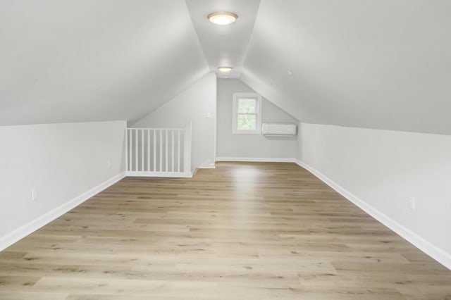 509 Hill St, Moncks Corner, SC 29461 - additional living space with an AC wall unit, lofted ceiling, light wood-style floors, and baseboards