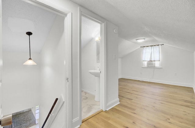 509 Hill St, Moncks Corner, SC 29461 - additional living space with lofted ceiling, a textured ceiling, light wood-style floors, cooling unit, and baseboards