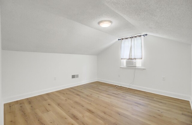 509 Hill St, Moncks Corner, SC 29461 - bonus room featuring a textured ceiling, baseboards, light wood-style floors, and lofted ceiling