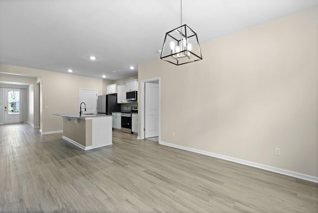318 Bering Ln, Summerville, SC 29486 - kitchen featuring a center island with sink, a sink, baseboards, stainless steel appliances, and white cabinetry