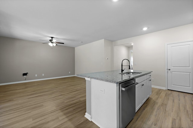 318 Bering Ln, Summerville, SC 29486 - kitchen with stainless steel dishwasher, ceiling fan, light wood-type flooring, white cabinets, and a sink