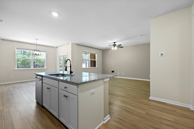 318 Bering Ln, Summerville, SC 29486 - kitchen featuring a sink, light wood-style flooring, ceiling fan with notable chandelier, baseboards, and stainless steel dishwasher