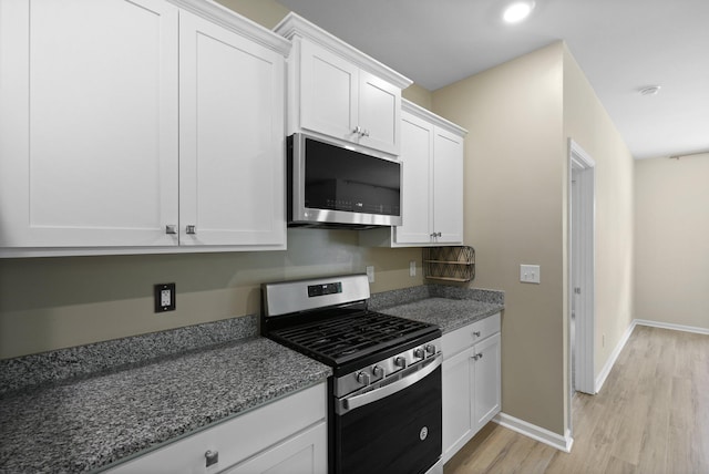 318 Bering Ln, Summerville, SC 29486 - kitchen featuring light stone countertops, light wood-style floors, baseboards, white cabinetry, and appliances with stainless steel finishes