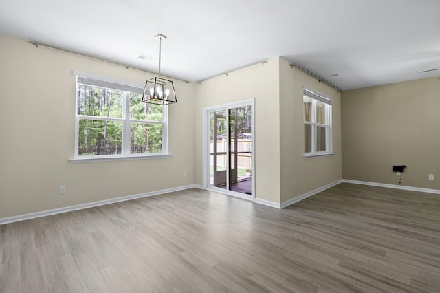 318 Bering Ln, Summerville, SC 29486 - unfurnished room with baseboards, wood finished floors, and a notable chandelier