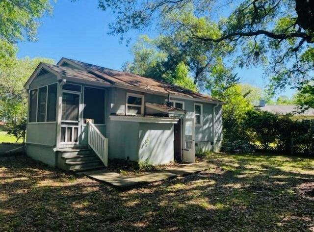 rear view of house with a sunroom