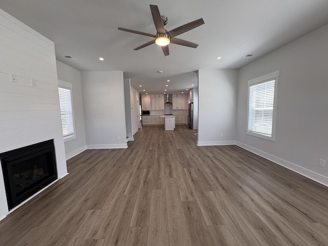819 Burger St, Charleston, SC 29407 - unfurnished living room with a ceiling fan, recessed lighting, a fireplace, dark wood-style floors, and healthy amount of natural light