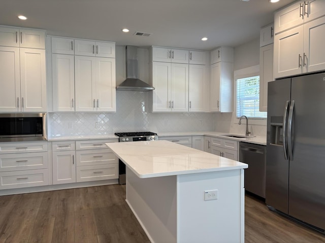 819 Burger St, Charleston, SC 29407 - kitchen with appliances with stainless steel finishes, wall chimney exhaust hood, a sink, dark wood-style flooring, and a kitchen island