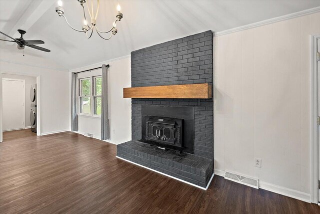 unfurnished living room with stacked washing maching and dryer, a brick fireplace, wood-type flooring, lofted ceiling with beams, and ceiling fan with notable chandelier