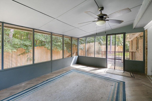 unfurnished sunroom featuring ceiling fan