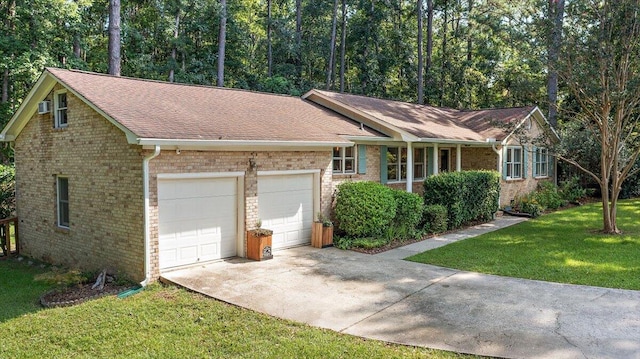 ranch-style home featuring a garage and a front yard