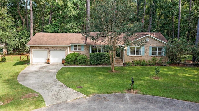 ranch-style home featuring a garage and a front lawn