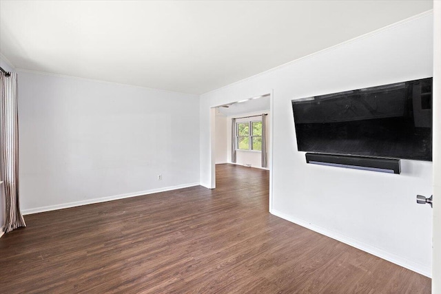 unfurnished living room with hardwood / wood-style flooring and ornamental molding