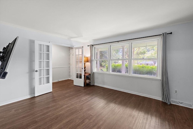 spare room with hardwood / wood-style flooring, french doors, and crown molding