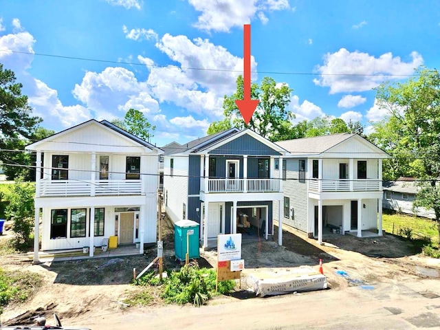 view of front facade with a balcony and driveway