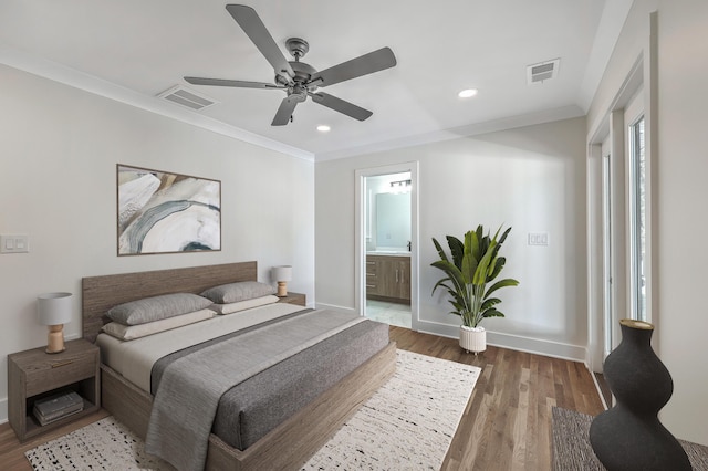 bedroom with ornamental molding, dark wood-style flooring, visible vents, and baseboards