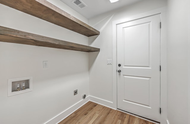 washroom with hookup for a washing machine, hookup for an electric dryer, visible vents, baseboards, and light wood finished floors