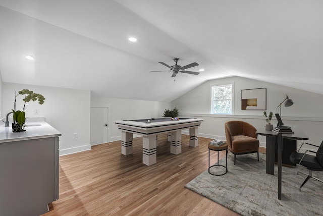 office area with a ceiling fan, lofted ceiling, baseboards, and light wood finished floors