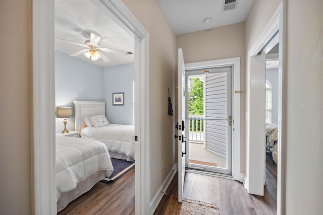 bedroom with ceiling fan, dark hardwood / wood-style floors, and access to outside