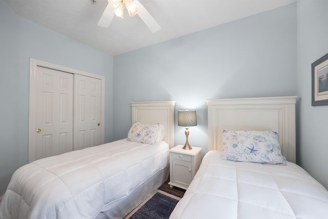 bedroom with ceiling fan, a closet, and wood-type flooring