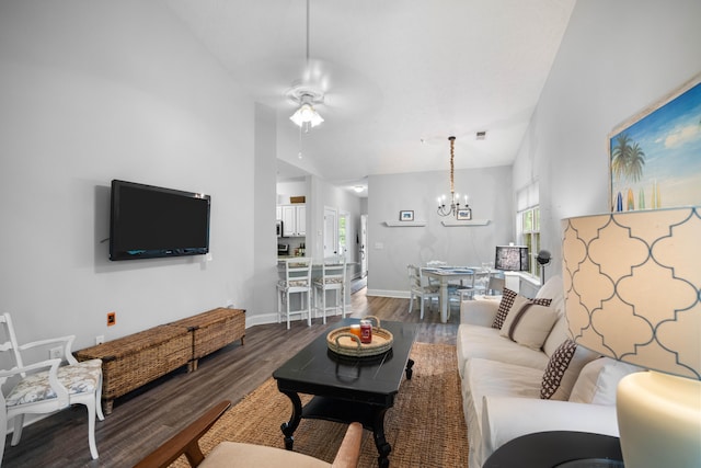 living room with lofted ceiling, ceiling fan with notable chandelier, and hardwood / wood-style floors