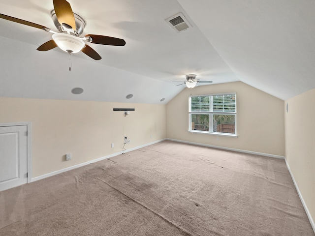 additional living space featuring ceiling fan, light carpet, and vaulted ceiling