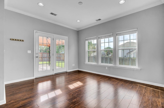 spare room with ornamental molding, dark hardwood / wood-style flooring, and a healthy amount of sunlight