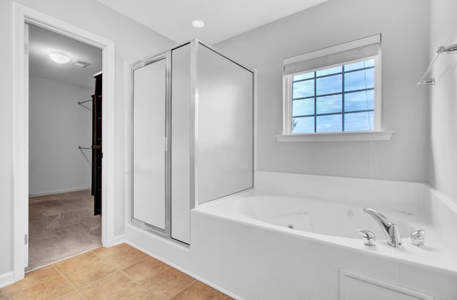 bathroom featuring tile patterned floors and separate shower and tub