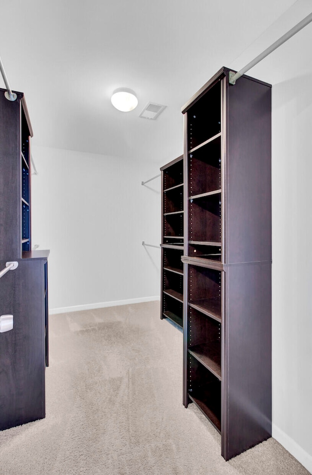 walk in closet with carpet flooring