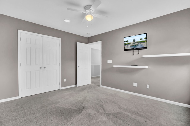 unfurnished bedroom with ceiling fan, carpet flooring, and a closet