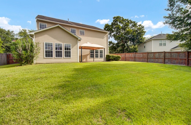 back of property featuring a lawn