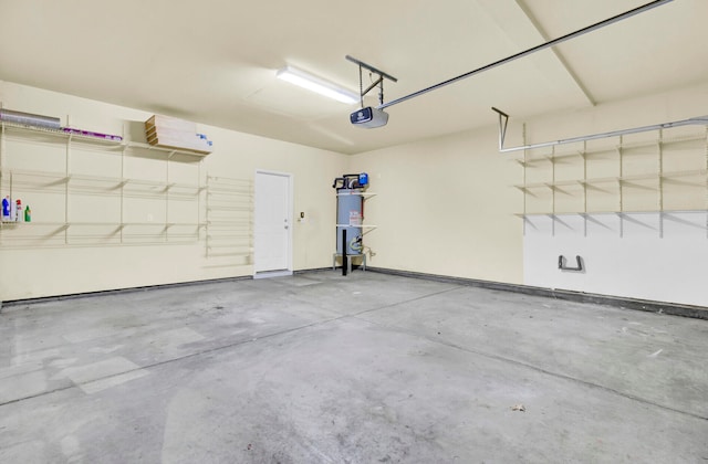 garage with a garage door opener and secured water heater