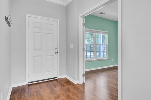 foyer entrance featuring dark hardwood / wood-style flooring and crown molding