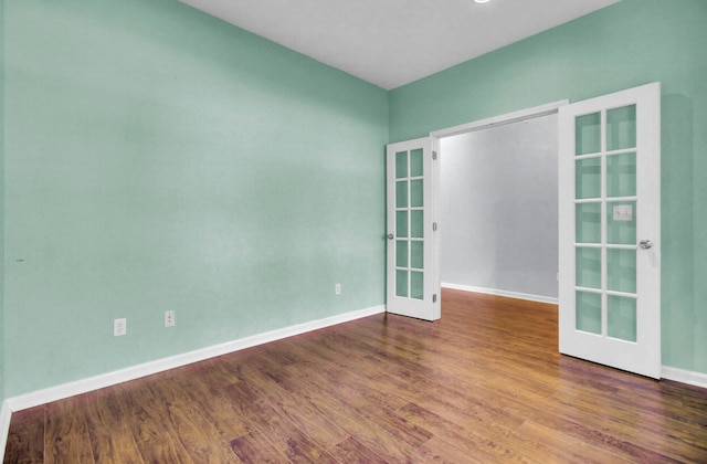 unfurnished room with wood-type flooring and french doors