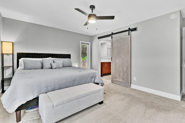 8 Pony Ln, Charleston, SC 29407 - bedroom featuring a barn door, light carpet, baseboards, ensuite bathroom, and ceiling fan