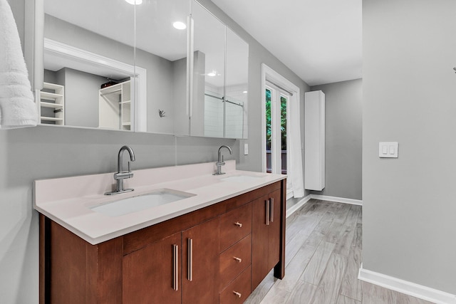 8 Pony Ln, Charleston, SC 29407 - bathroom with double vanity, baseboards, a shower with shower door, and radiator
