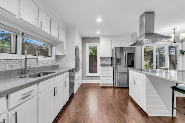 8 Pony Ln, Charleston, SC 29407 - kitchen with appliances with stainless steel finishes, island exhaust hood, a sink, tasteful backsplash, and dark wood-style floors