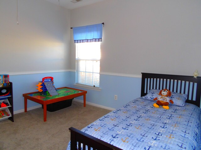 carpeted bedroom with visible vents and baseboards