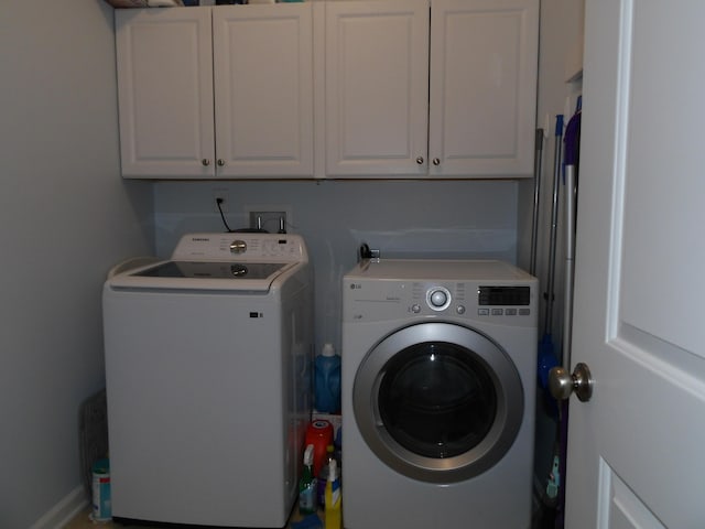 laundry room featuring washer and clothes dryer and cabinet space