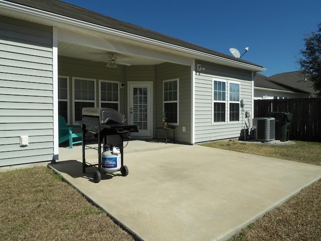 view of patio with fence, a grill, a ceiling fan, and central air condition unit