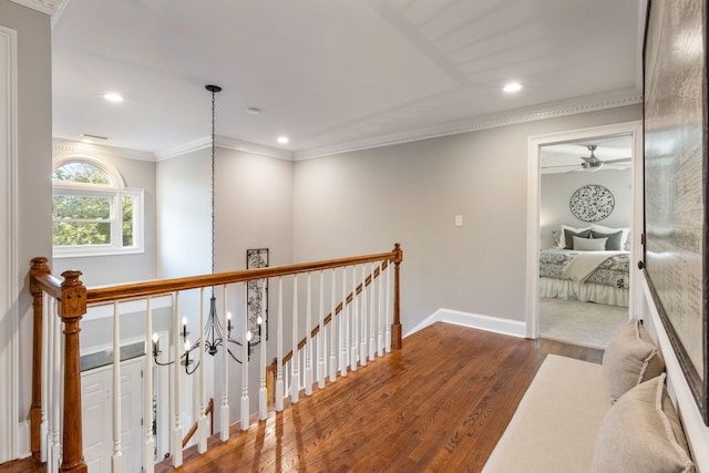 hallway with dark hardwood / wood-style flooring, a chandelier, and crown molding