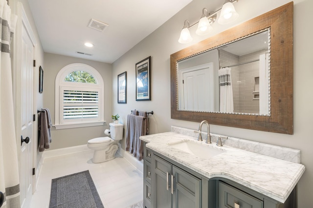 bathroom with tile patterned flooring, vanity, toilet, and a shower with curtain