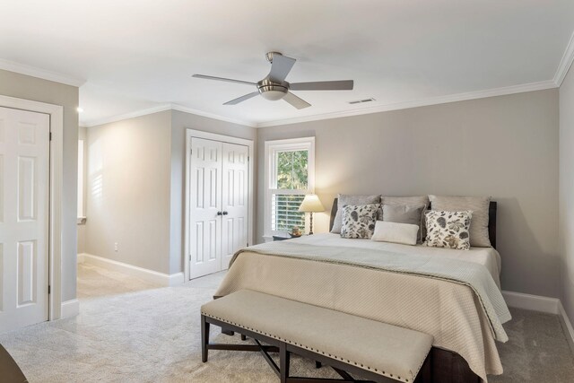 carpeted bedroom with ceiling fan and ornamental molding