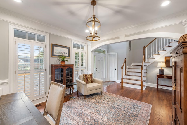 interior space featuring dark hardwood / wood-style flooring, a chandelier, and crown molding