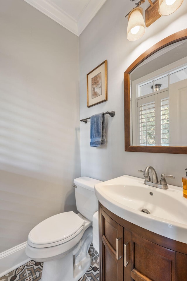 bathroom featuring toilet, vanity, tile patterned floors, and crown molding