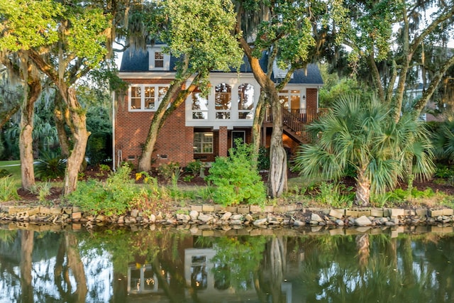 rear view of property with a water view