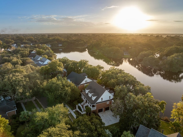 aerial view at dusk featuring a water view