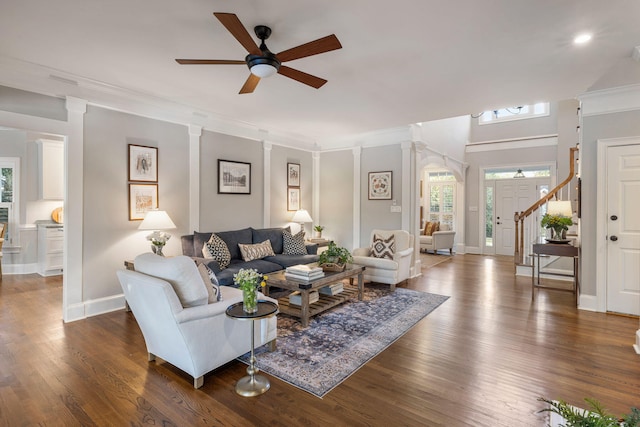 living room featuring ornamental molding, dark hardwood / wood-style floors, ceiling fan, and decorative columns