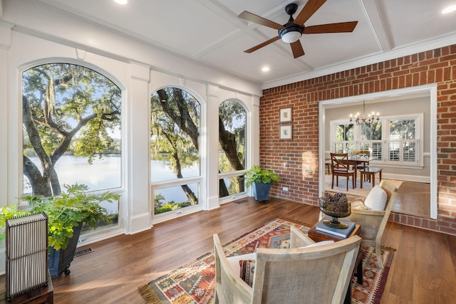 sunroom / solarium featuring beam ceiling, a water view, coffered ceiling, and ceiling fan with notable chandelier