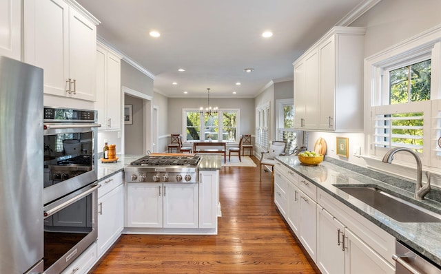 kitchen with a healthy amount of sunlight, sink, and white cabinets